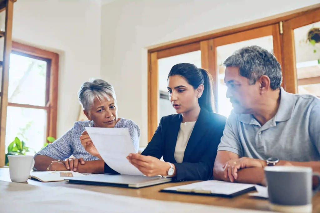 Estate management process, with documents and family members discussing, legal paperwork on a desk, professional setting.